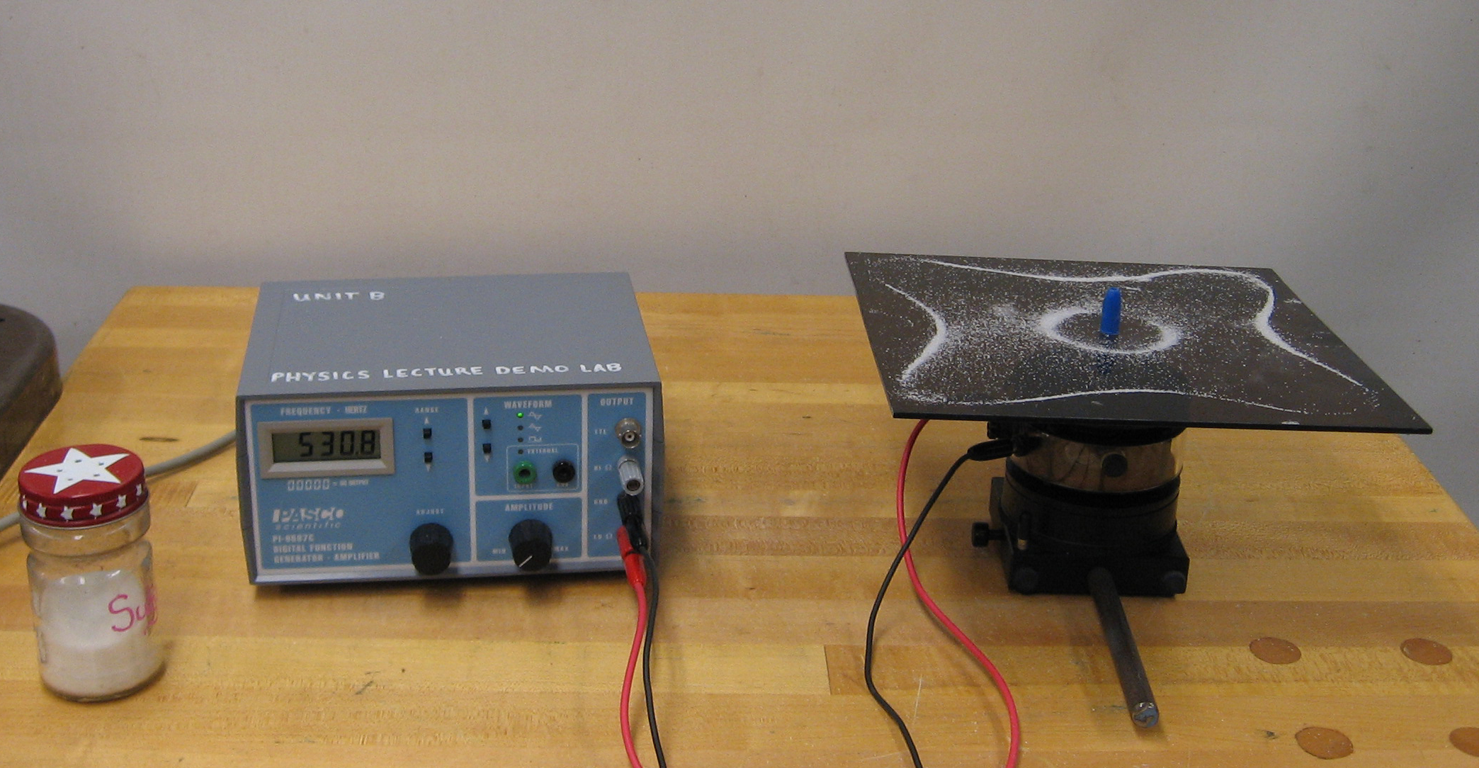 Picture of sand being manipulated by sound waves on a vibrating metal plate. Visualizing sound was featured in our Weekly Flavor.