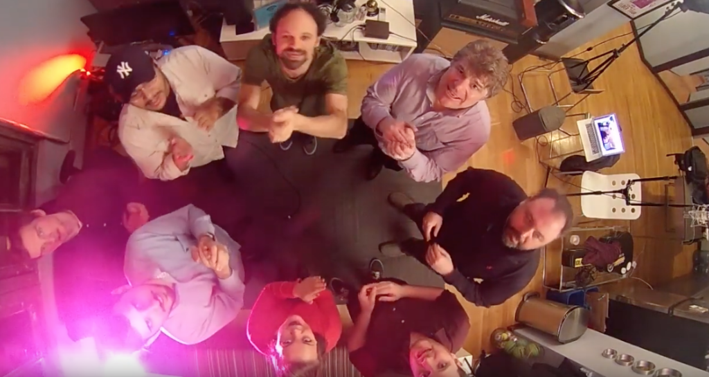 A picture of the Flavorlab staff standing in a circle looking up at the ceiling and clapping along to the team's Happy New Year song.